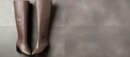 Photo of brown boots on a tiled floor with empty space for text or other elements with copy space