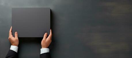 Photo of a person holding a square object with copy space for your text or design with copy space