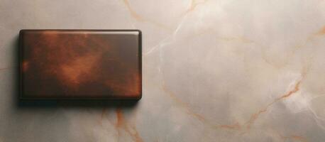 Photo of a minimalist brown square object on a clean white wall with plenty of copy space with copy space