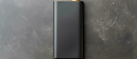 Photo of a black lighter on a gray background with plenty of copy space with copy space