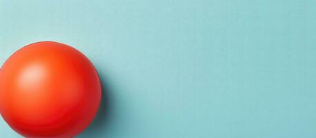 Photo of a red egg on a blue surface with ample copy space with copy space