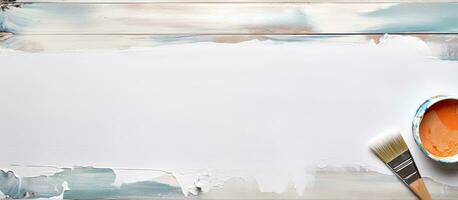 Photo of a paint can and paintbrush on a white background with copy space