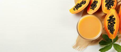 Photo of fresh papaya slices and a refreshing cup of juice with copy space