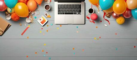 Photo of a laptop surrounded by colorful balloons and confetti, perfect for celebrating a special occasion with copy space