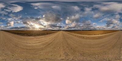 360 hdri panorama on gravel road with evening clouds on blue sky before sunset in equirectangular spherical seamless projection, use as sky replacement in drone panoramas, game development as sky dome photo