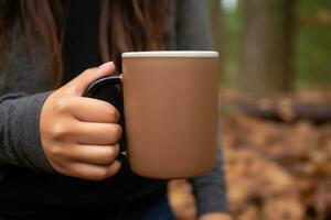 Closeup of female hands with a mug of beverage. Girl holding cup of tea or coffee. Generative AI photo