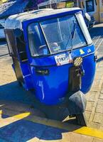 Puerto Escondido Oaxaca Mexico 2023 Blue tuk tuk white TukTuks rickshaw in Mexico. photo