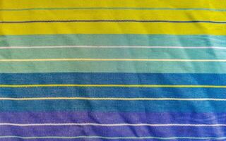 Colorful blue purple green striped table cloth texture in Mexico. photo