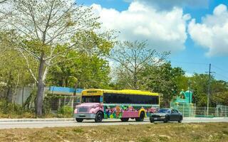 Playa del Carmen Qiuntana Roo Mexico 2023 Colorful pink yellow green Xcaret bus Playa del Carmen Mexico. photo