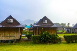 Wooden bamboo cottages in natural tropical jungle resort Krabi Thailand. photo
