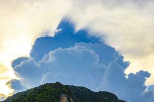 Explosive mysterious clouds come out from behind limestone rocks Thailand. photo