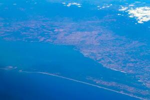 Flying by plane over Mexico view of volcanoes mountains clouds. photo