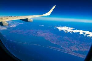 Flying by plane over Mexico view of volcanoes mountains clouds. photo