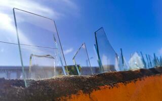 Dangerous wall with broken glass shards Playa del Carmen Mexico. photo