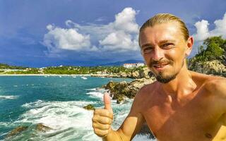 Selfie with rocks cliffs view waves beach Puerto Escondido Mexico. photo