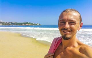 Selfie with rocks cliffs view waves beach Puerto Escondido Mexico. photo