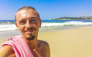 Selfie with rocks cliffs view waves beach Puerto Escondido Mexico. photo