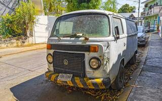 Puerto Escondido Oaxaca Mexico 2023 Old vintage classic minibuses vans transporters vehicles cars in Mexico. photo