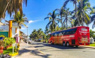 Puerto Escondido Oaxaca Mexico 2023 Various colorful buses tour bus transport in Puerto Escondido Mexico. photo