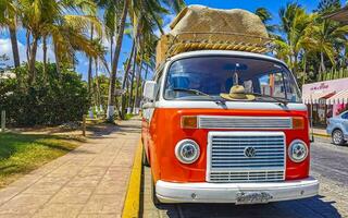 Puerto Escondido Oaxaca Mexico 2023 Old vintage classic minibuses vans transporters vehicles cars in Mexico. photo