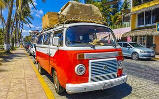 Puerto Escondido Oaxaca Mexico 2023 Old vintage classic minibuses vans transporters vehicles cars in Mexico. photo