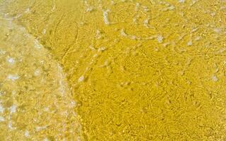 Wet beach sand water and waves texture and pattern in Mexico. photo