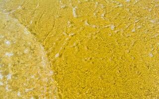 Wet beach sand water and waves texture and pattern in Mexico. photo