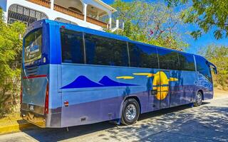 Puerto Escondido Oaxaca Mexico 2023 Various colorful buses tour bus transport in Puerto Escondido Mexico. photo