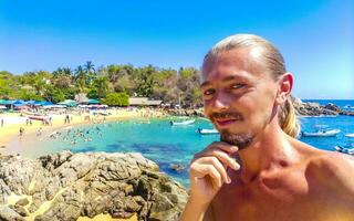 Selfie with rocks cliffs view waves beach Puerto Escondido Mexico. photo