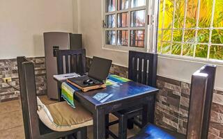 Simple small apartment hotel room with bed table in Mexico. photo