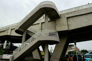 The concrete bridge structure is very sturdy and intersects with other road structures. photo