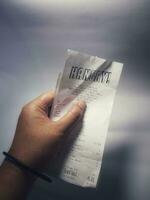 Bekasi, Indonesia on December 1, 2022. A hand is holding a receipt from a restaurant called Hangry photo