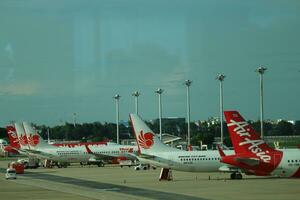 Bangkok, Thailand on July 9, 2023. Air Asia airplane on the apron of Don Mueang International Airport. photo