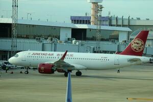 Bangkok, Thailand on July 9, 2023. Juneyao Air plane on the apron of Don Mueang International Airport. photo