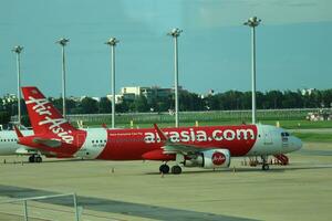 Bangkok, Thailand on July 9, 2023. Air Asia airplane on the apron of Don Mueang International Airport. photo