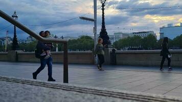 Beautiful Low Angle Footage of Tourist People are Walking Along Pathway of London Eye at Westminster Central London City of England Great Britain, Footage Was Captured on Aug 02nd, 2023 During Sunset. video