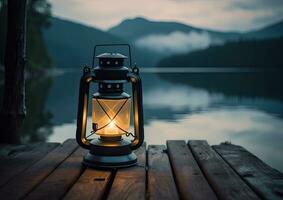 Old kerosene lantern with warm yellow light on a bridge by a lake in the evening. Burning lantern on a stone in the moonlight. The light of the sun reflecting Created with Generative AI technology. photo