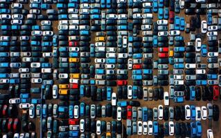 Aerial view new car lined up in the port for import and export business logistic to dealership for sale, Automobile and automotive car parking lot. Created with Generative AI technology. photo