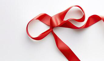 Delicate red wavy ribbon isolated on white background. New Year or Christmas holidays decoration concept. Created with Generative AI technology. photo