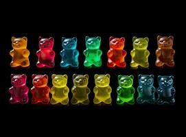 Jelly bears on a black background. Multicolored sweets on a black background. Created with Generative AI technology. photo