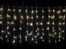 Light bulb decor on a dark background, at night. Created with Generative AI technology. photo