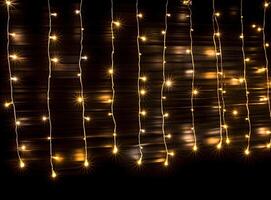 Light bulb decor on a dark background, at night. Created with Generative AI technology. photo