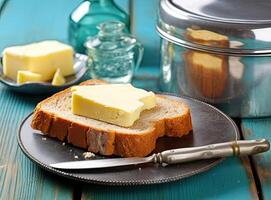 Foil wrapped processed cream cheese, table knife and slice of bread on a cutting board over blue wooden table. Small triangular pieces of soft cheese. Created with Generative AI technology. photo