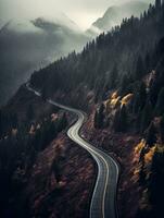 Dark misty day with empty Winding mountain road. Created with Generative AI technology. photo