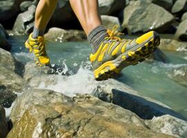 Woman athlete is jumping over stones in mountains. Created with Generative AI technology. photo