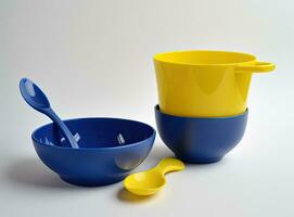 Arrange the tableware used in the camp. Compact silicone utensils. Compact travel utensils. Travel utensils and an army knife on stones. View from above. Created with Generative AI technology. photo