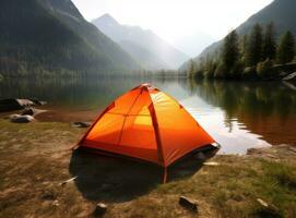 tourist lit tent by the lake at sunset. Dramatic sky. Orange lit inside the tent and a fire over the misty river at sunset. Dramatic sunset. Summer landscape. Created with Generative AI technology. photo