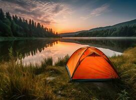 tourist lit tent by the lake at sunset. Dramatic sky. Orange lit inside the tent and a fire over the misty river at sunset. Dramatic sunset. Summer landscape. Created with Generative AI technology. photo