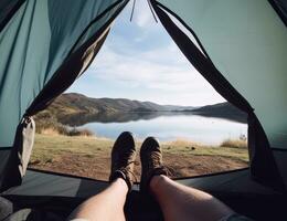 Shoes, camping and tent with a couple by a lake out in nature while hiking for adventure or travel together. Created with Generative AI technology. photo