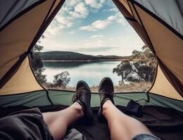 Shoes, camping and tent with a couple by a lake out in nature while hiking for adventure or travel together. Created with Generative AI technology. photo